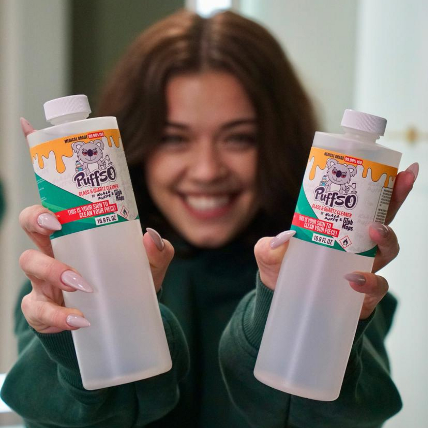 Glob Mops x Koala Puffs Puffso 99.99% ISO alcohol bottle held in hand